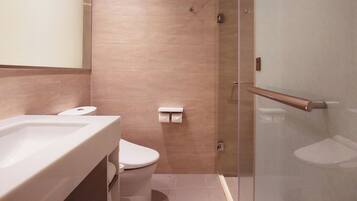 A bathroom with a bathtub, toilet, and shower.