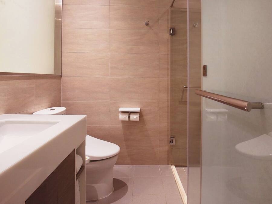 A bathroom with a bathtub, toilet, and shower.