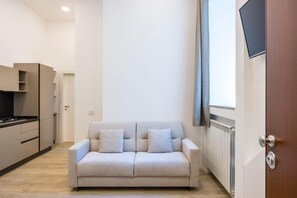 Apartment (1 Bedroom) | Living area | 32-inch Smart TV with cable channels