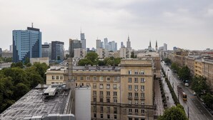 A cityscape with a mix of modern and historic buildings, a tram line, and a clear sky. - ShortStayPoland Marszałkowska B188 (Warsaw)