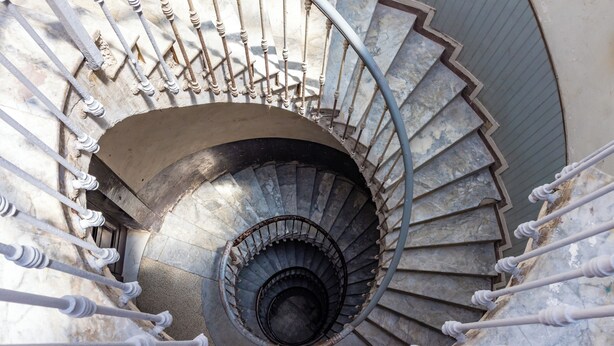 Eine Treppe im Windelstil mit aufwendiger Balustrade und Marmorverkleidung.