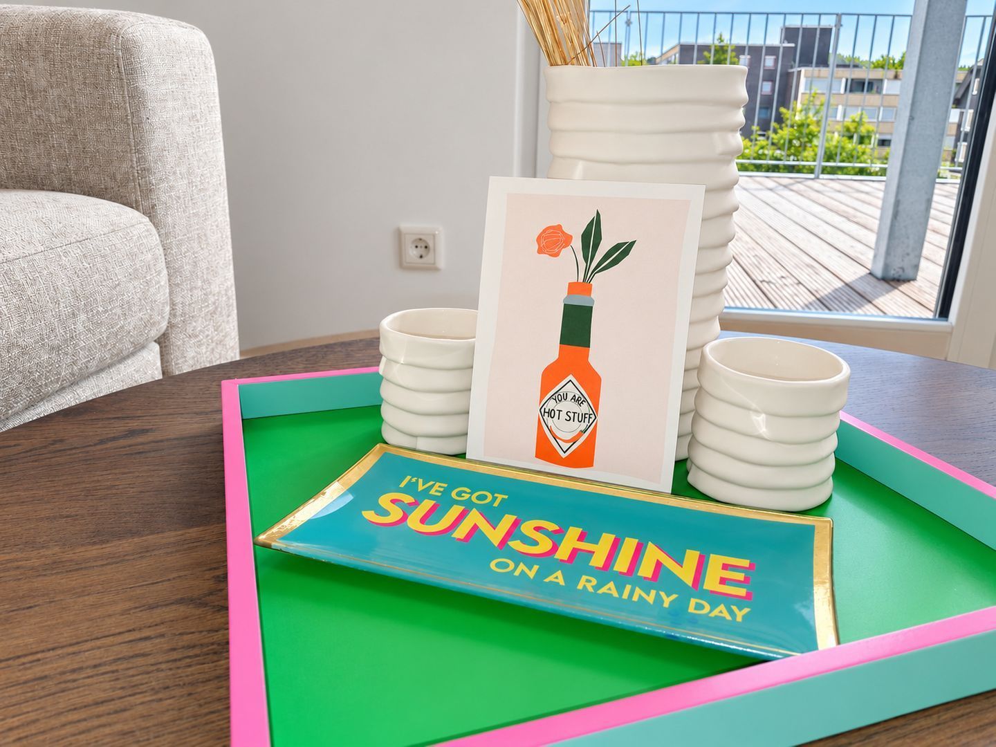A table with a card, a tray, and stacked plates.