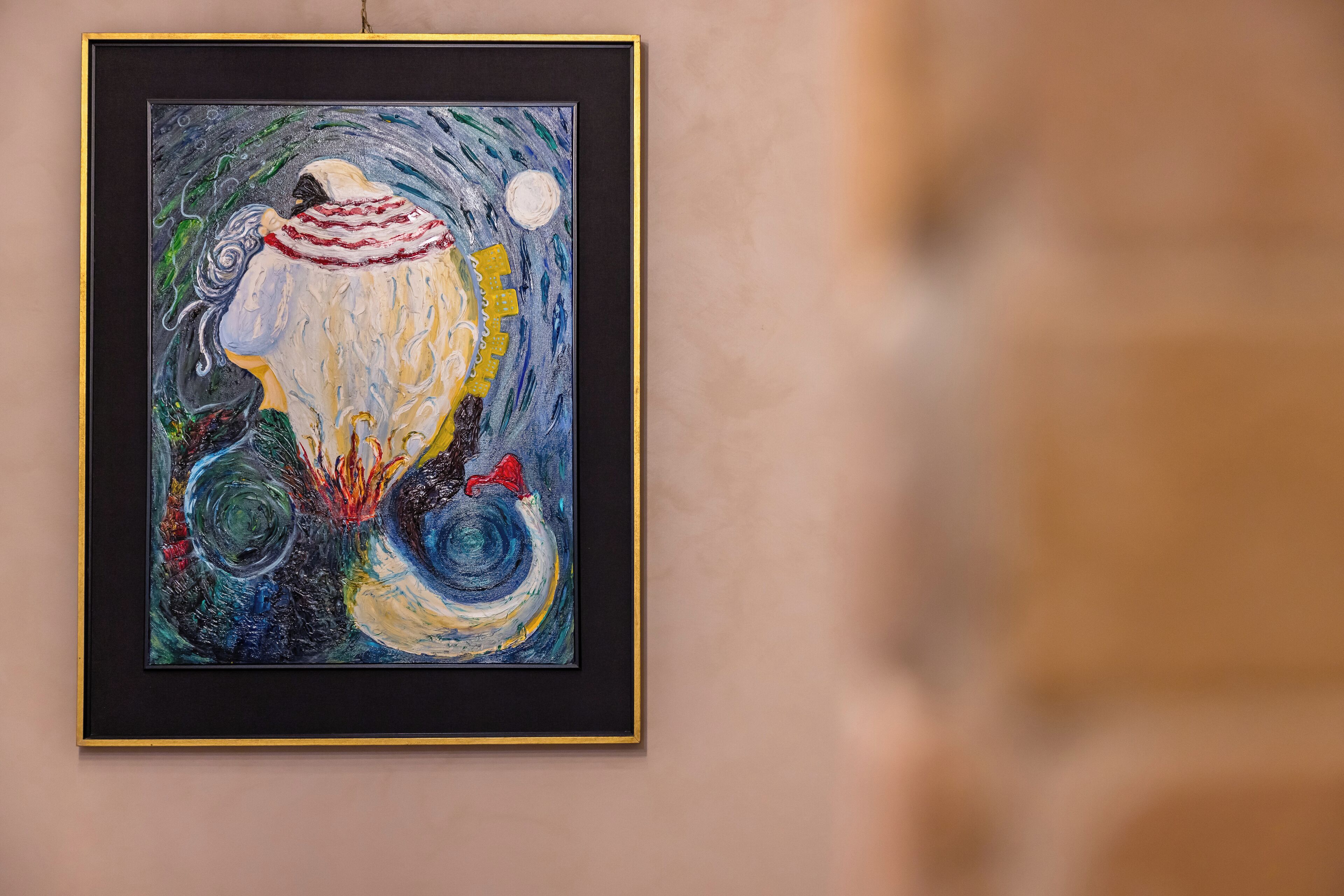 A framed painting on a wall.