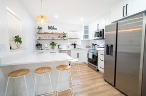 Fridge, dishwasher, coffee/tea maker, cookware/dishes/utensils