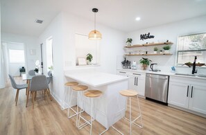 Fridge, dishwasher, coffee/tea maker, cookware/dishes/utensils