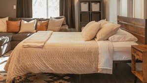 A bedroom with a bed, a nightstand, a dresser, and a window with curtains. - The Barn ~Minutes from Snoqualmie Casino! (Snoqualmie)