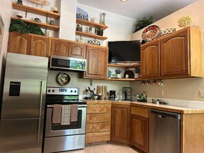 Fridge, coffee/tea maker, high chair, cookware/dishes/utensils
