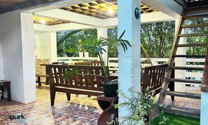 A family room with a river view, featuring a tiled floor, wooden furniture, and potted plants. - FAMILY HOUSE WITH PRIVATE KITCHEN, TOILET AND LIVING ROOM (AURORA - BALER (CAPITAL))