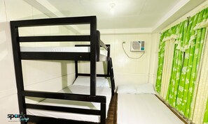 A family room with bunk beds, a green curtain, and an air conditioning unit. - FAMILY HOUSE WITH PRIVATE KITCHEN, TOILET AND LIVING ROOM (AURORA - BALER (CAPITAL))