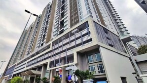 A high-rise residential building with multiple balconies and a modern architectural design. - Central Residence - Free Gym Pool (Kuala Lumpur)