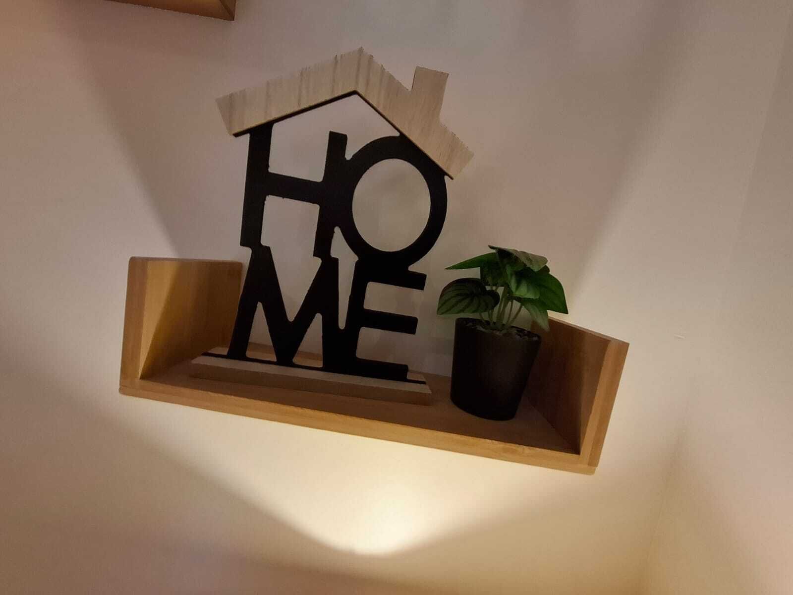 A wooden shelf with the words "HOME" and a house-shaped cutout.