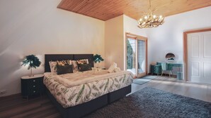 A bedroom with a bed, bedside table, lamp, and a desk with a chair. - La Moneta Retreat – A Sanctuary for Healing & Hope -Tranquil Hillside Haven (Dean)