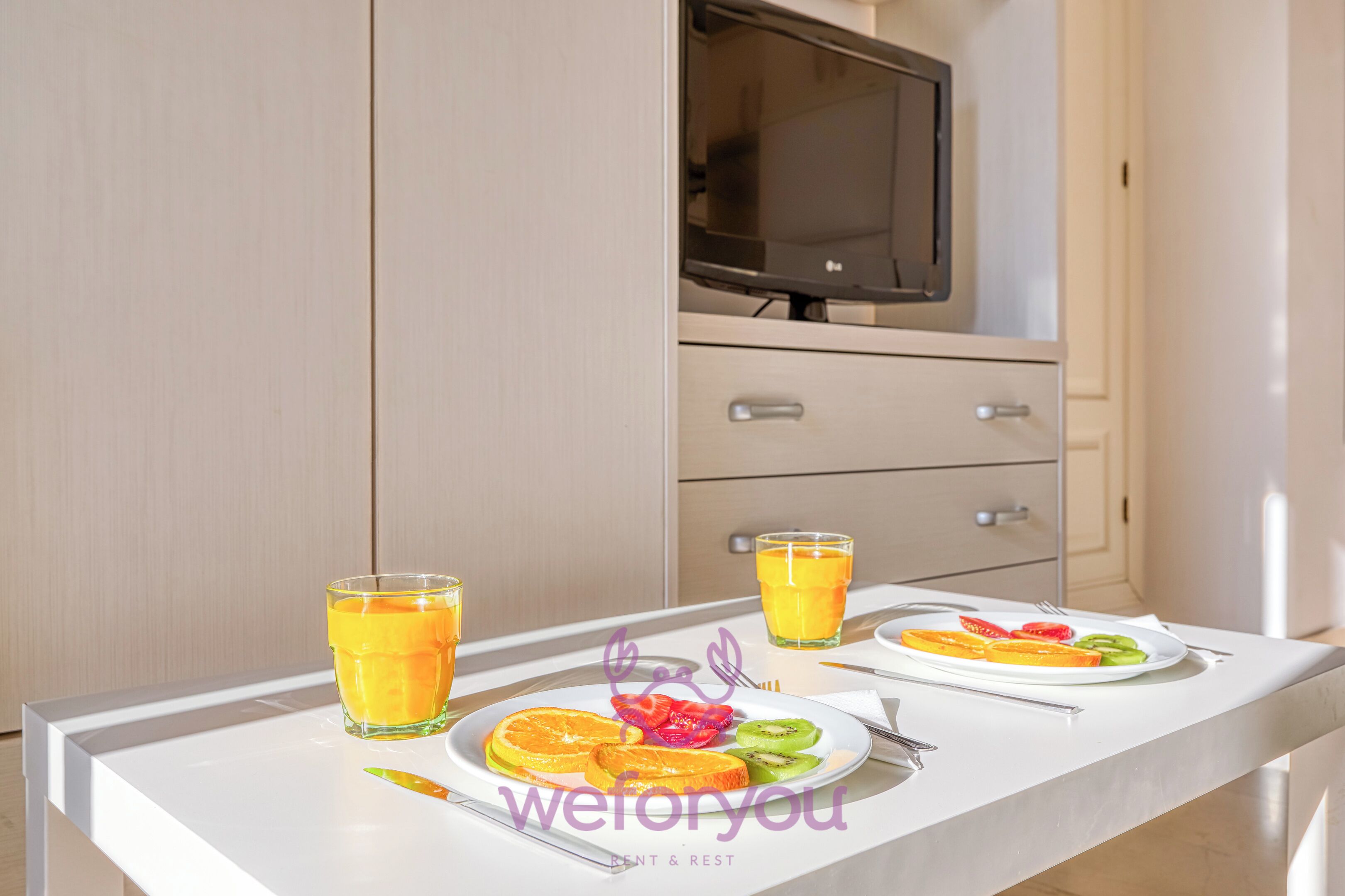 Comfort Studio, Balcony, City View | Living area | 50-inch Smart TV with cable channels