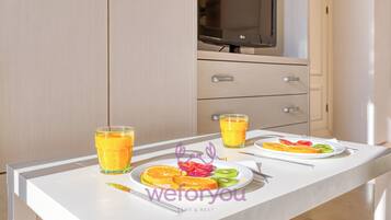 Comfort Studio, Balcony, City View | Living area | 50-inch Smart TV with cable channels