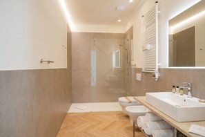 A modern bathroom with a large sink, toilet, and shower area. - PalazzoTorre 101 - Luxury Apartment & Terrace (Bari)