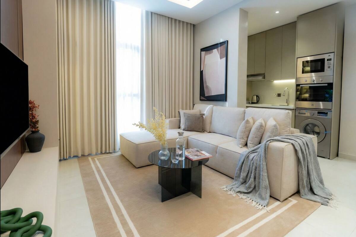 A modern living room with a sofa, coffee table, and a flat-screen TV.