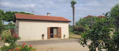 A small, single-story building with a tiled roof and a door.