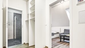 A modern interior with a shower, a sofa, and a coffee table.