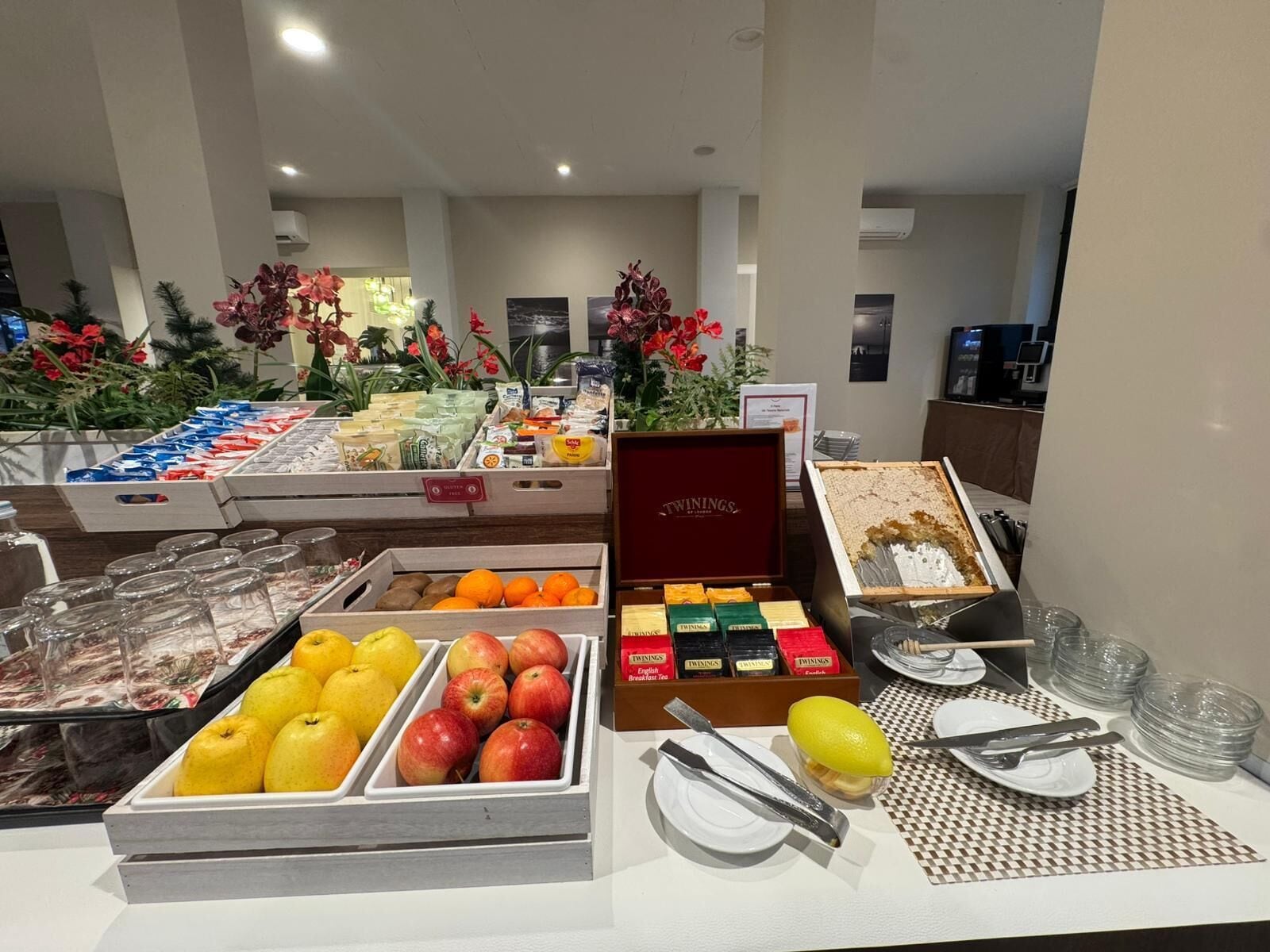 A buffet with various food items, including fruits, beverages, and a selection of breakfast items.
