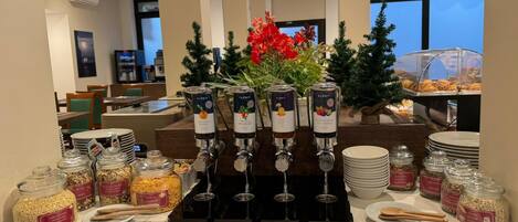 A breakfast buffet with various food items and beverages.