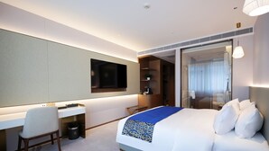 A modern hotel room with a large bed, a desk, and a television. - Southern Airlines Pearl Hotel (Guangzhou)