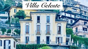 Villa Celeste, a large building with multiple balconies and a stone staircase leading up to it.