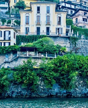 Villa Celeste, a large building with multiple balconies and a stone staircase leading up to it.