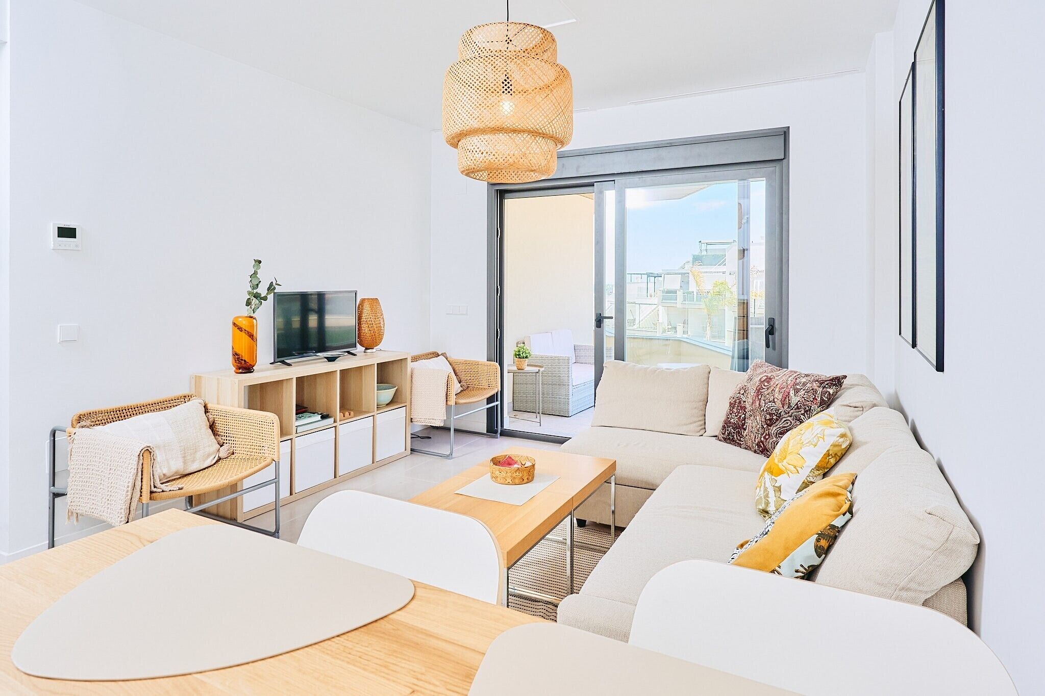 A modern living room with a sofa, coffee table, and TV.