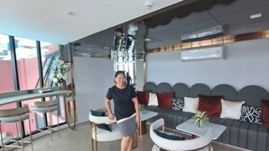 Eine moderne Hotelhalle mit Sitzgelegenheiten, einer Couch und einer Bar.