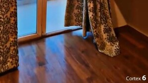A room with a sliding glass door leading to a balcony. The room has wooden flooring and a dark-colored bench along the wall. - Hotel Raj Villa (Jodhpur)