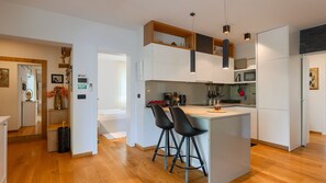 A modern kitchen with a central island, bar stools, and a microwave. - Villa Dila by Villas Guide (Medulin)