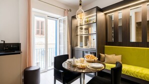 Un salon moderne comprenant une table à manger, un canapé et une bibliothèque intégrée.