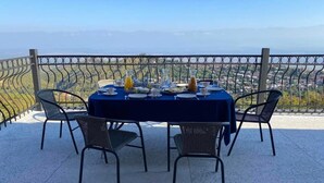 A table set for dining with a view of a cityscape.