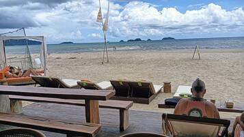 Beach nearby, white sand, beach umbrellas, beach towels