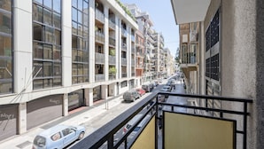 A multi-story building with balconies, a street view, and parked cars. - AuGuStea Urban Studio (Bari)