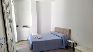 A bedroom with a bed, a bedside table, a bench, and a wardrobe. - La Campetella. Relaxation within walking distance of downtown. (Ischia)