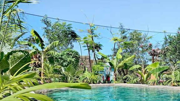A clear pool with a stone edge and a plate of food on the side. - Villa Noemi by the Sea (Bwejuu)