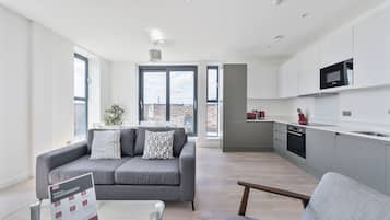 Apartment, 4 Bedrooms | Living area | 40-inch Smart TV with digital channels, iPod dock