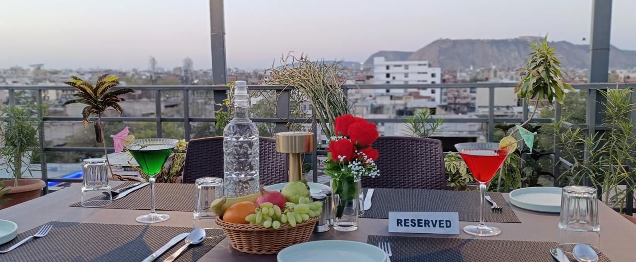 A table set for two with a view of a cityscape.