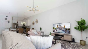 Una sala moderna con sofá, mesa de centro y televisor. Se observa una zona de comedor con mesa y sillas, y una cocina al fondo.