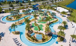 A resort with a large pool area, palm trees, and lounge chairs. - Lake View Resort Condo w Lazy River Near Disney (Kissimmee)