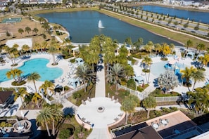 An aerial view of a resort with multiple swimming pools, palm trees, and a central plaza with seating areas. - Splendid 6Bd w Private Pool Solara Resort 2154 (Kissimmee)