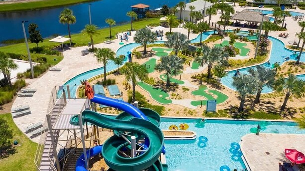 A resort with a large pool, water slides, and a golf course. - Family 5BD Spa Pool Game Loft Near Disney (Kissimmee)