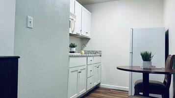 Mini-fridge, microwave, stovetop, cookware/dishes/utensils