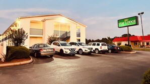 A Stay Lodge building with a parking lot, several cars, and a signboard. - Stay Lodge Decatur (Decatur)