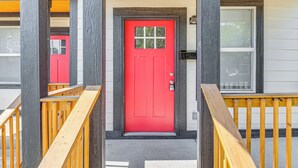 A red door with a small window, a mailbox, and a wooden staircase leading to the entrance. - Sip, Dine & Explore Fountain Square: Indy Retreat! (Indianapolis)