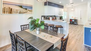 A dining area with a wooden table, chairs, and a decorative centerpiece. - Golf & Hike: Family Home in Rotonda West! (Rotonda West)