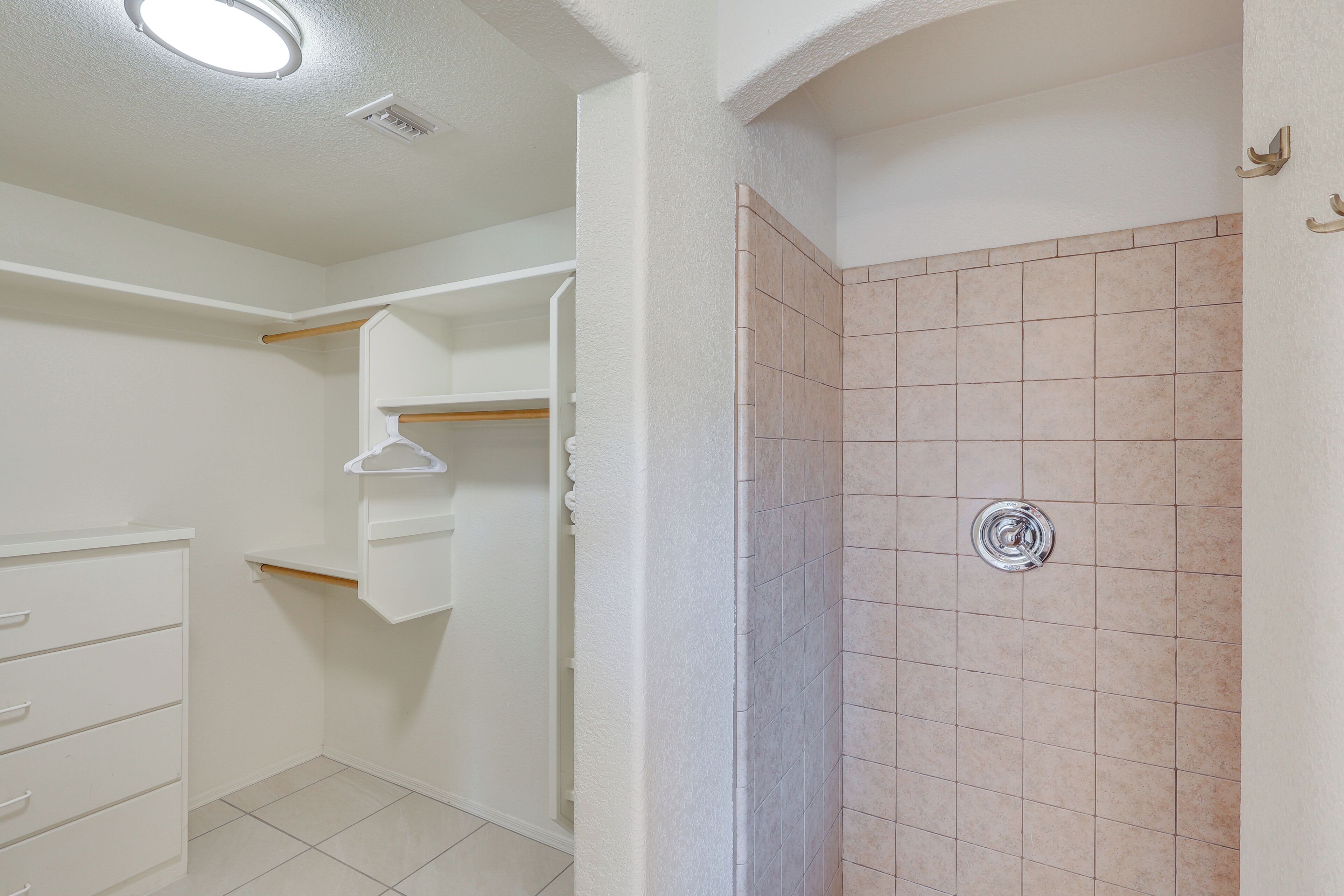 A bathroom with a shower, a toilet, and a sink.