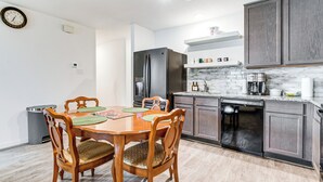 A modern kitchen with a dining table, chairs, a refrigerator, and a dishwasher. - Lake Conroe Home w/ Yard: Half-mi to Boating! (Willis)