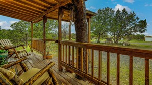 A wooden deck with a railing, a tree trunk, and a view of the surrounding landscape. - Quiet Eagar Retreat Near Lakes, Hiking & Hunting! (Eagar)